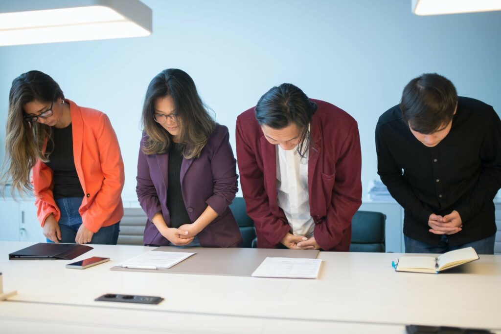 a group of people bowing