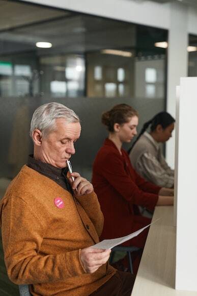 A Male Voter Reviewing His Ballot