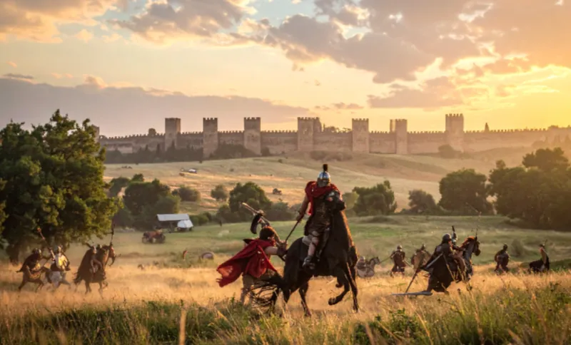 Momentka z víťazného boja Etruskov proti Rimanom. Bitka prebieha na lúke a v diaľke na pozadí vidno hradby mesta, na lúke v pozadí sú vozy rímskeho tábora.